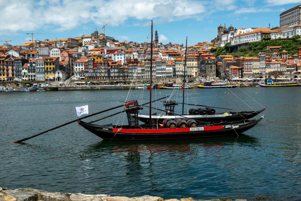 Scenic view of Barco Rabelo on the Douro River with Porto in the background, Portugal.